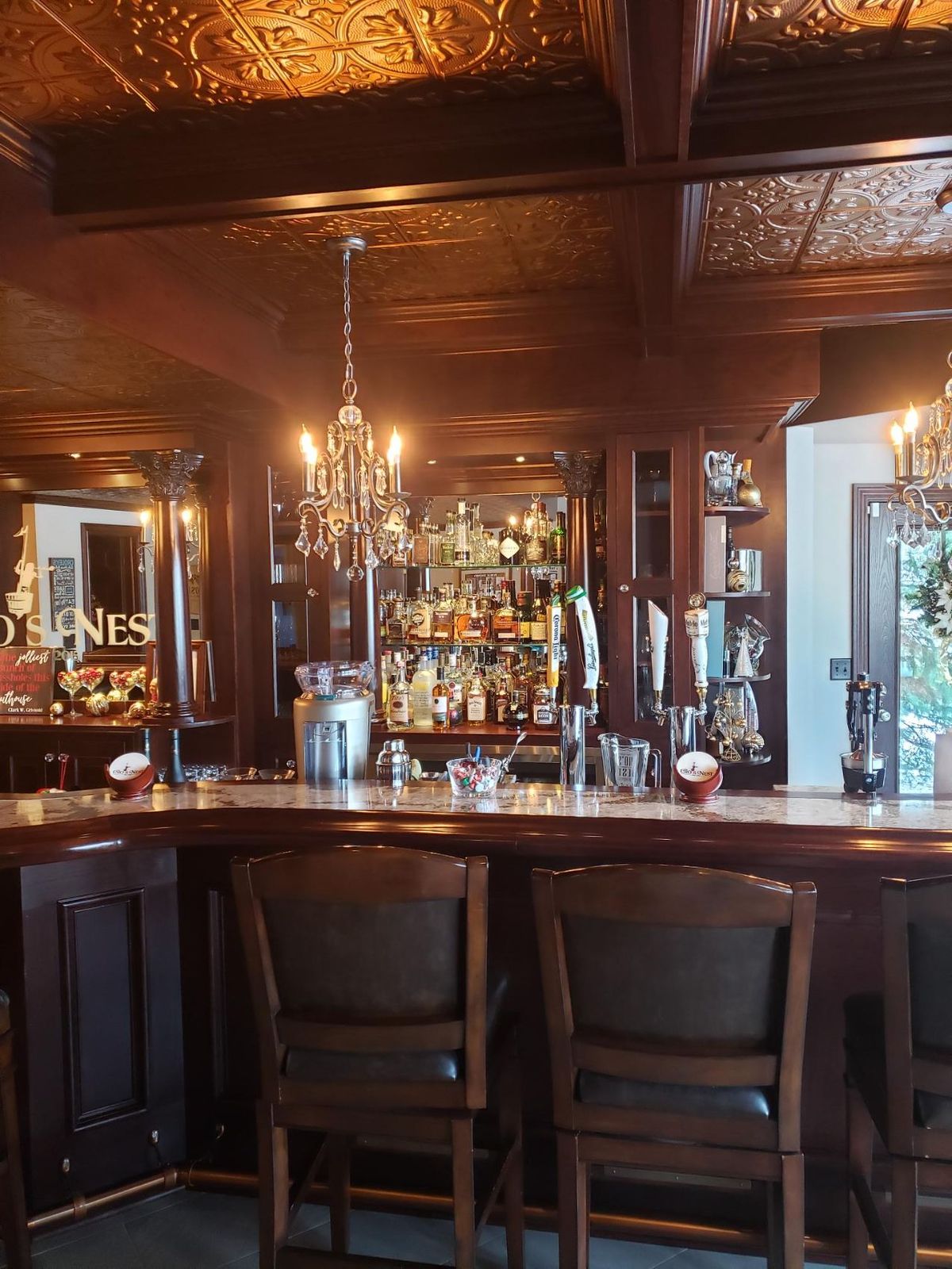Stools along the bar beneath the pressed-copper ceiling